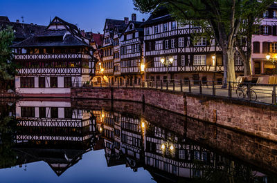 Reflection of illuminated buildings in city at night