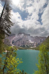 Scenic view of river against cloudy sky