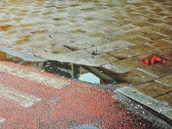 High angle view of puddle on footpath