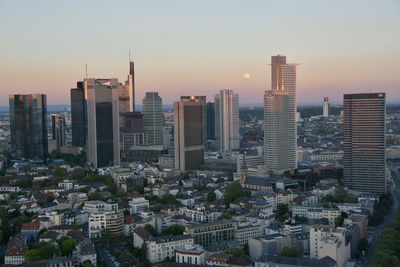 Aerial view of buildings in city against sky