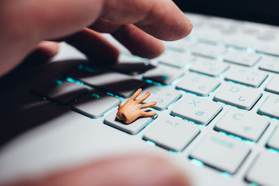 Close-up of person using keyboard but small hand on the key