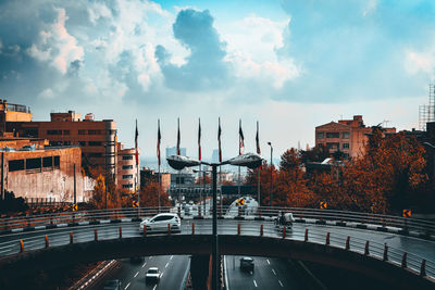 Bridge over city buildings against sky