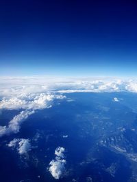 Aerial view of cloudscape over sea against blue sky