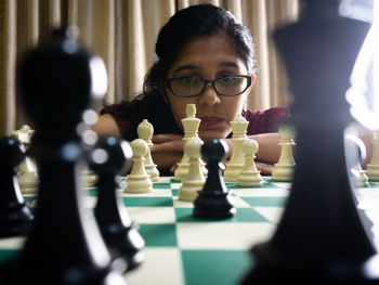 Close-up of woman playing chess