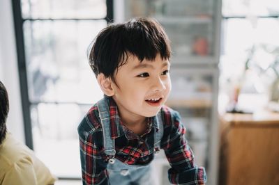 Cute boy looking away at home