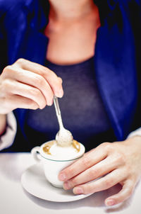 Woman holding coffee cup