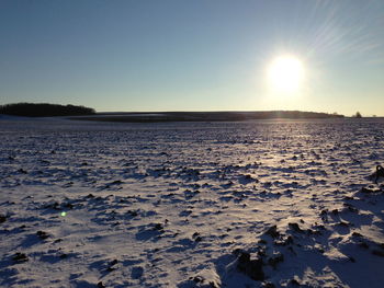 Scenic view of frozen lake against sky during sunset