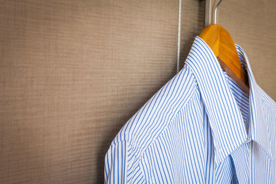 Close-up of striped shirt hanging at home
