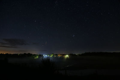 Scenic view of silhouette landscape against star field at night