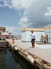 Full length of man standing on boat against sky