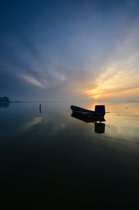 Scenic view of lake against sky during sunset