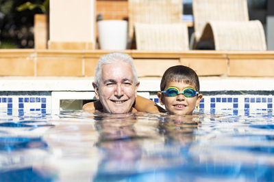 Portrait of boy swimming in pool