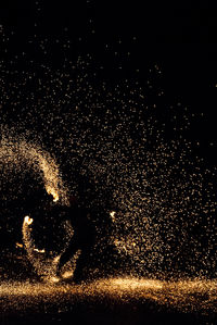 Firework display against sky at night