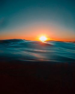 Scenic view of sea against clear sky during sunset