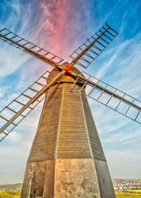 Low angle view of traditional windmill against sky