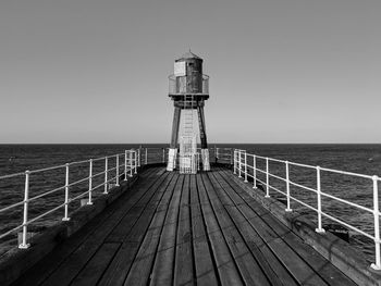 Pier over sea against clear sky