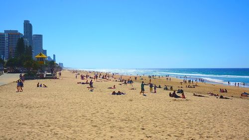 Scenic view of beach against blue sky