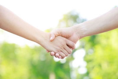 Cropped image of couple holding hands