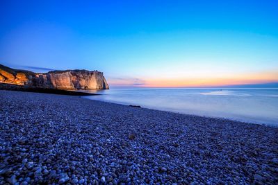 Scenic view of sea against clear blue sky
