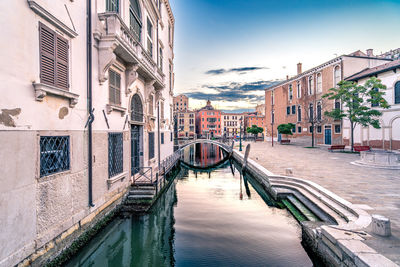 Canal amidst buildings in city