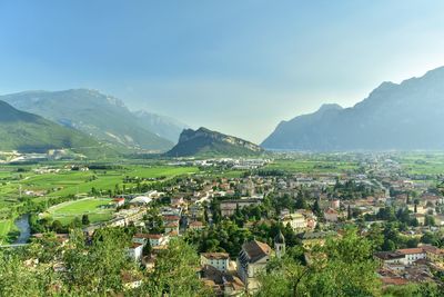 Aerial view of townscape and mountains against sky