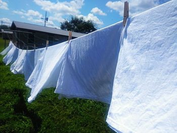 Clothes drying on clothesline against sky