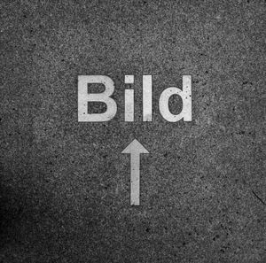 Close-up of blid text with arrow symbol on road