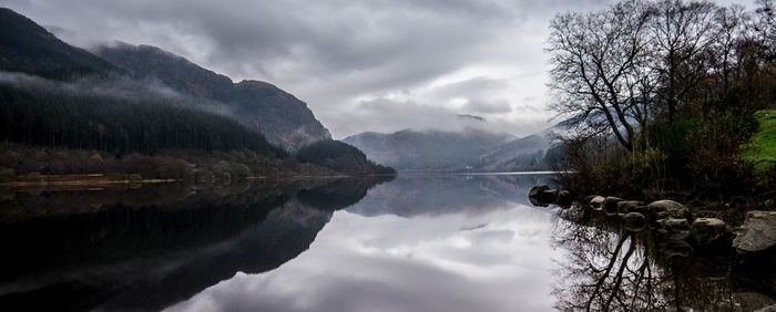 Scenic view of lake against cloudy sky