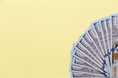 Close-up of yellow paper over colored background