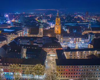 Aerial view of illuminated buildings in city at night