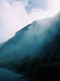 Scenic view of mountains against cloudy sky