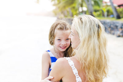 Happy mother with girl at beach