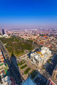 High angle view of buildings against clear blue sky