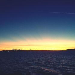 Scenic view of sea against clear sky during sunset