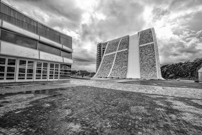 Low angle view of building against cloudy sky