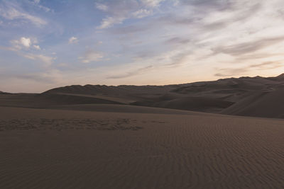 Footprints on rippled sand by sand dunes