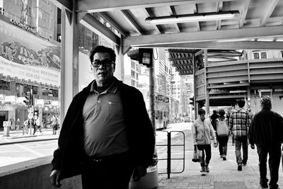 Man and woman walking in city against building