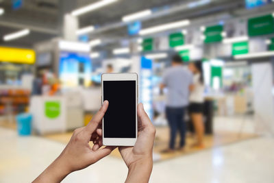 Close-up of hand holding mobile phone