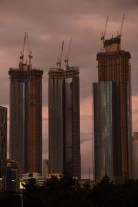 Buildings in city against sky during sunset