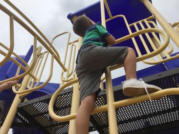 Rear view of boy climbing steps