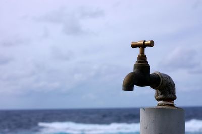 Close-up of water pipe on beach