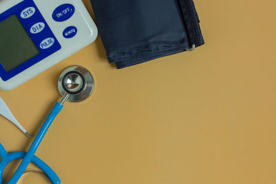 High angle view of medical equipment over beige background