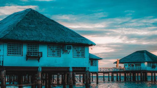 Built structure by sea against sky