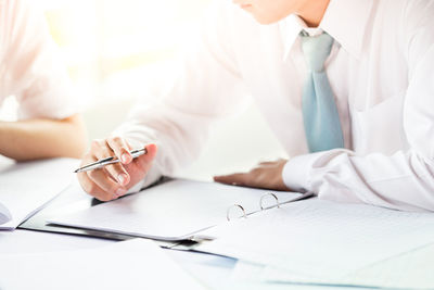 Midsection of woman working on table