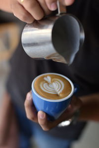 Close-up of man holding coffee cup