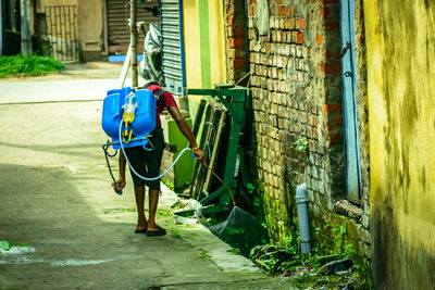 Rear view of person against building