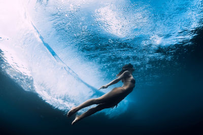 Low section of woman swimming in sea