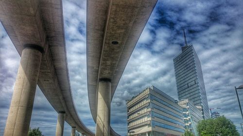 Low angle view of bridge against cloudy sky