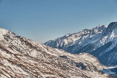 Scenic view of snowcapped mountains against clear sky