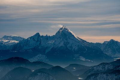 Scenic view of snowcapped mountains against sky during sunset